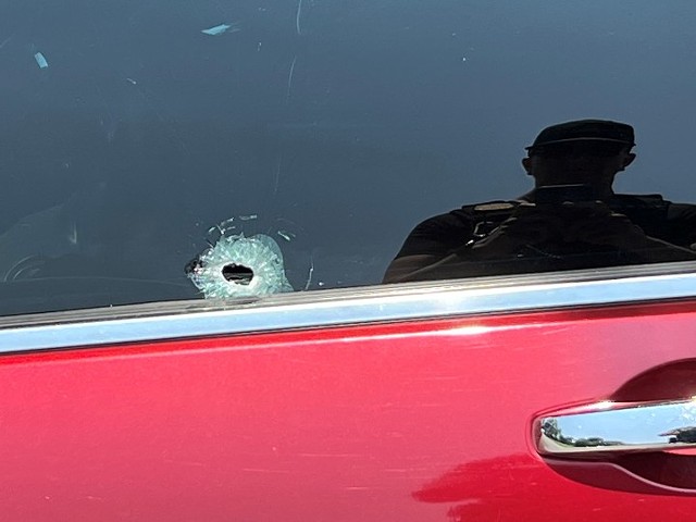 Bullet holes in an unmarked police car.