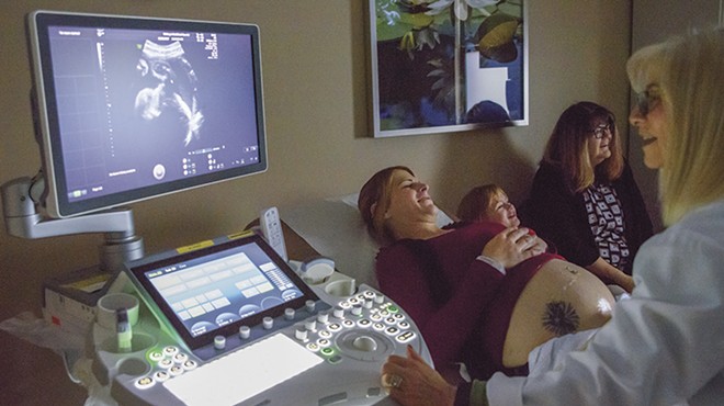 Dr. Jaye Shyken, right, performs an ultrasound on Rio Clemens at the WISH Center.
