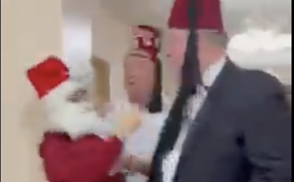 Protester Sasha Monik, dressed as Santa, can be seen in a video filmed by a fellow protester getting shoved by a Shriner.