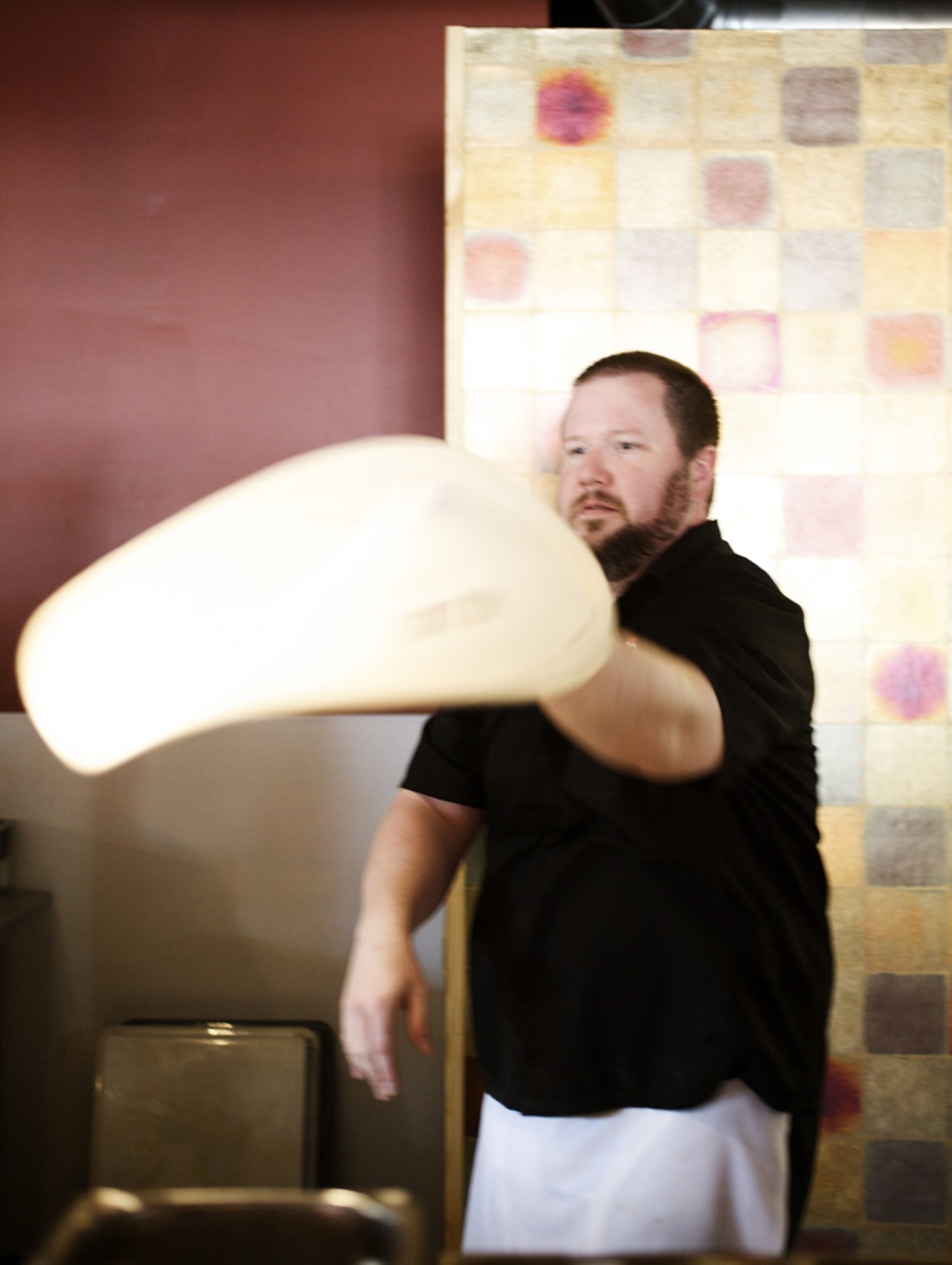 Executive kitchen manager Randall Eickmeyer tosses the pizza dough.