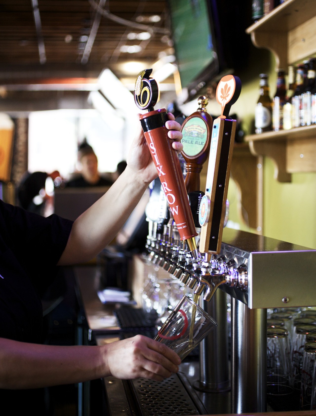 Bartender Renee Ludwig pours a pint from local Six Row Brewing.