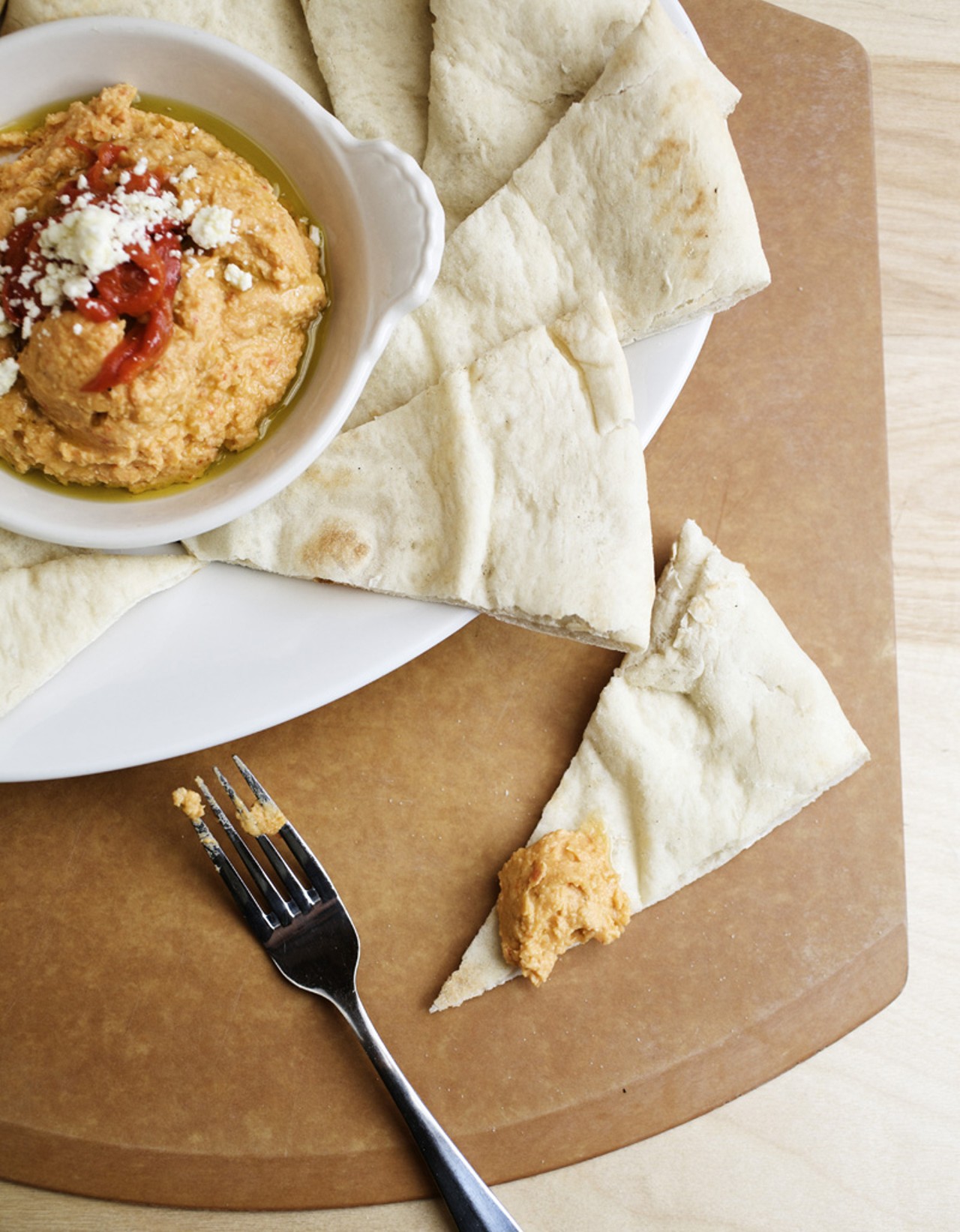 Roasted Red Pepper Hummus appetizer is served with warm pita or fresh vegetables (not shown.)