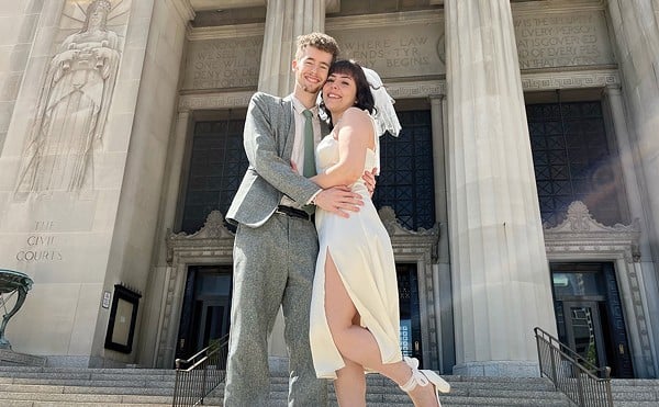 Adam Jehle, 20, and Julia Lima, 18, standing outside of the courthouse after getting married.
