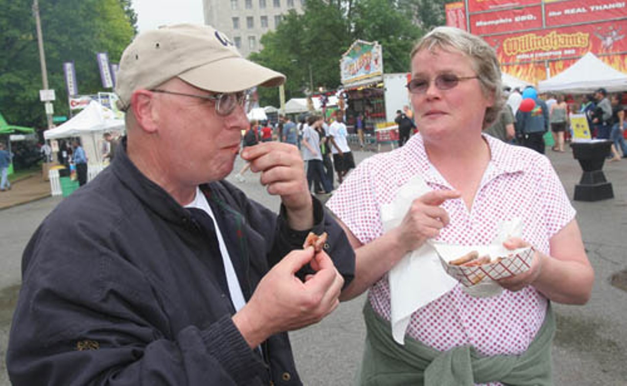 Joel Dean finishes off his barbecue ribs while Sue Dean collects the bones.