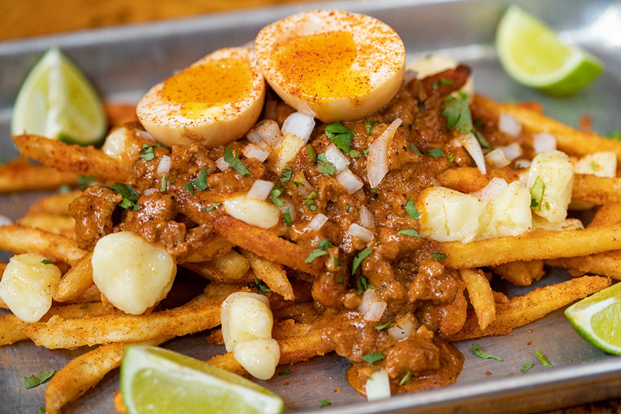 Poutina Turner with Rock Star Dusted fries topped with cheddar cheese curds, chorizo gravy, onions, cilantro and limes.