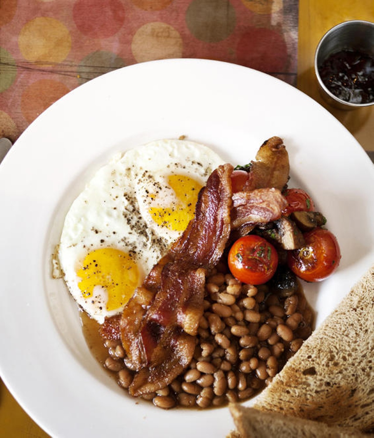The English Breakfast. Fried eggs, bacon, beans, toast, tomato and sauteed mushroom.