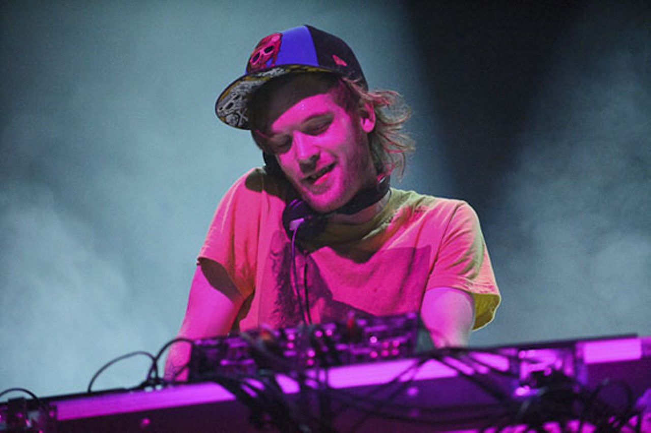 Lit up in colors, Rusko performing.