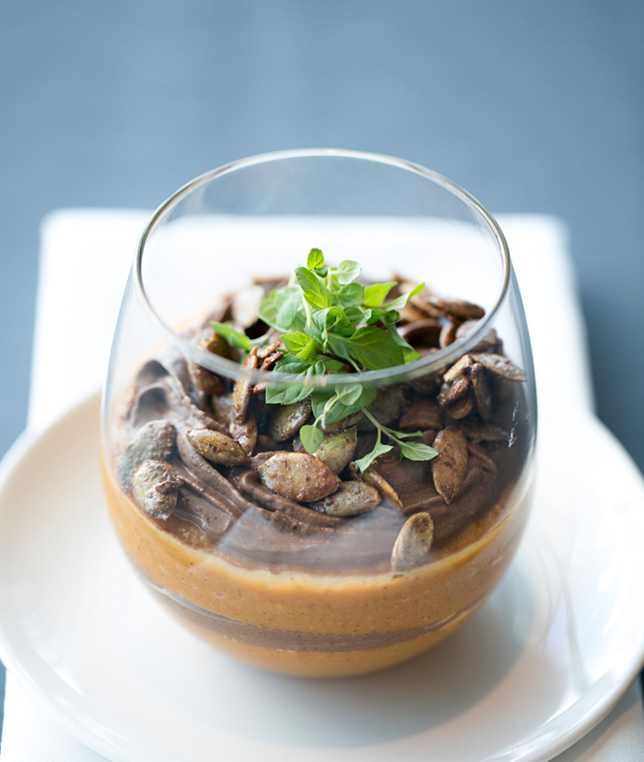 "A Mosaic of Sweet Potato Pudding" features chocolate-orange mousse, maple candied pumpkin seeds.