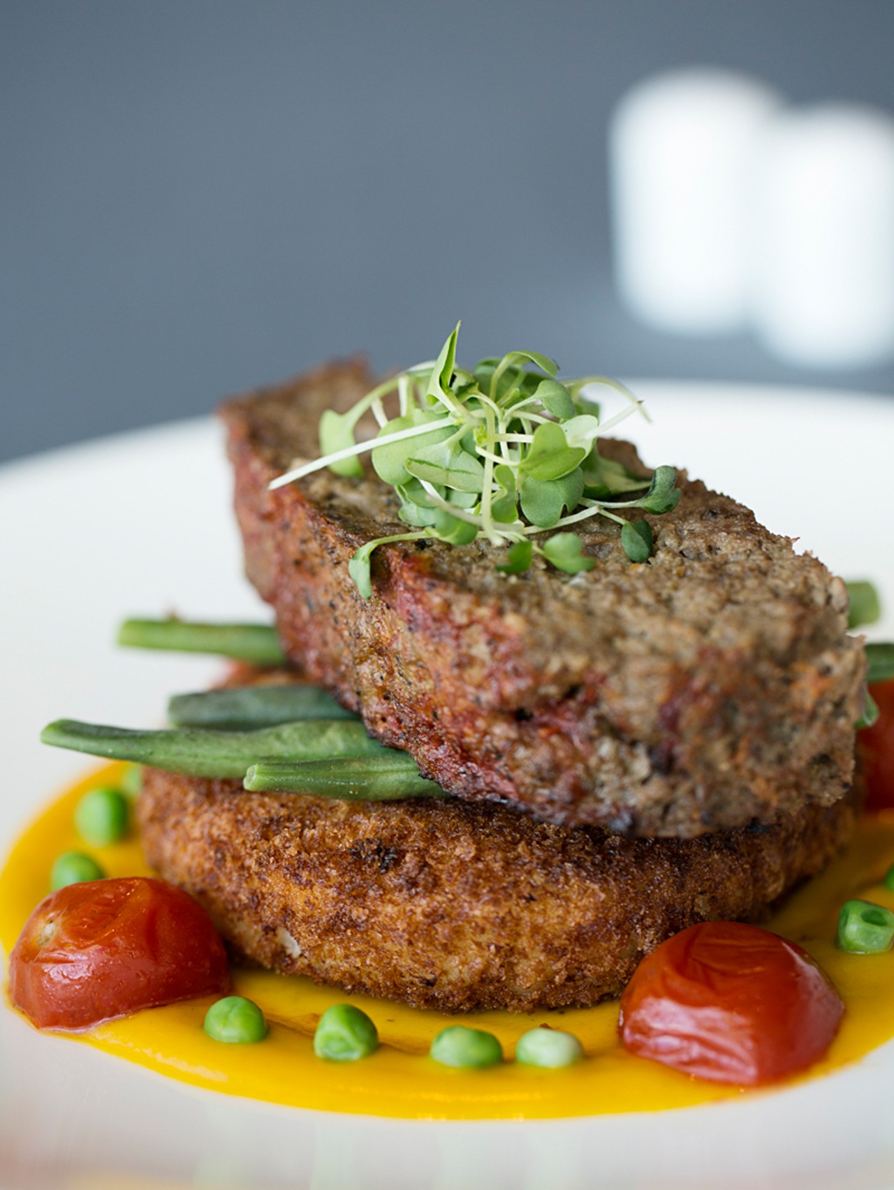 The meatloaf is made with local grass-fed beef and comes with horseradish potato cake, string beans and onions, and roasted carrot coulis.