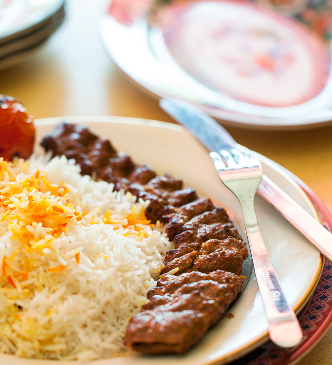 "Beef Kobeedah" is served with basmati rice and grilled Roma tomatoes.