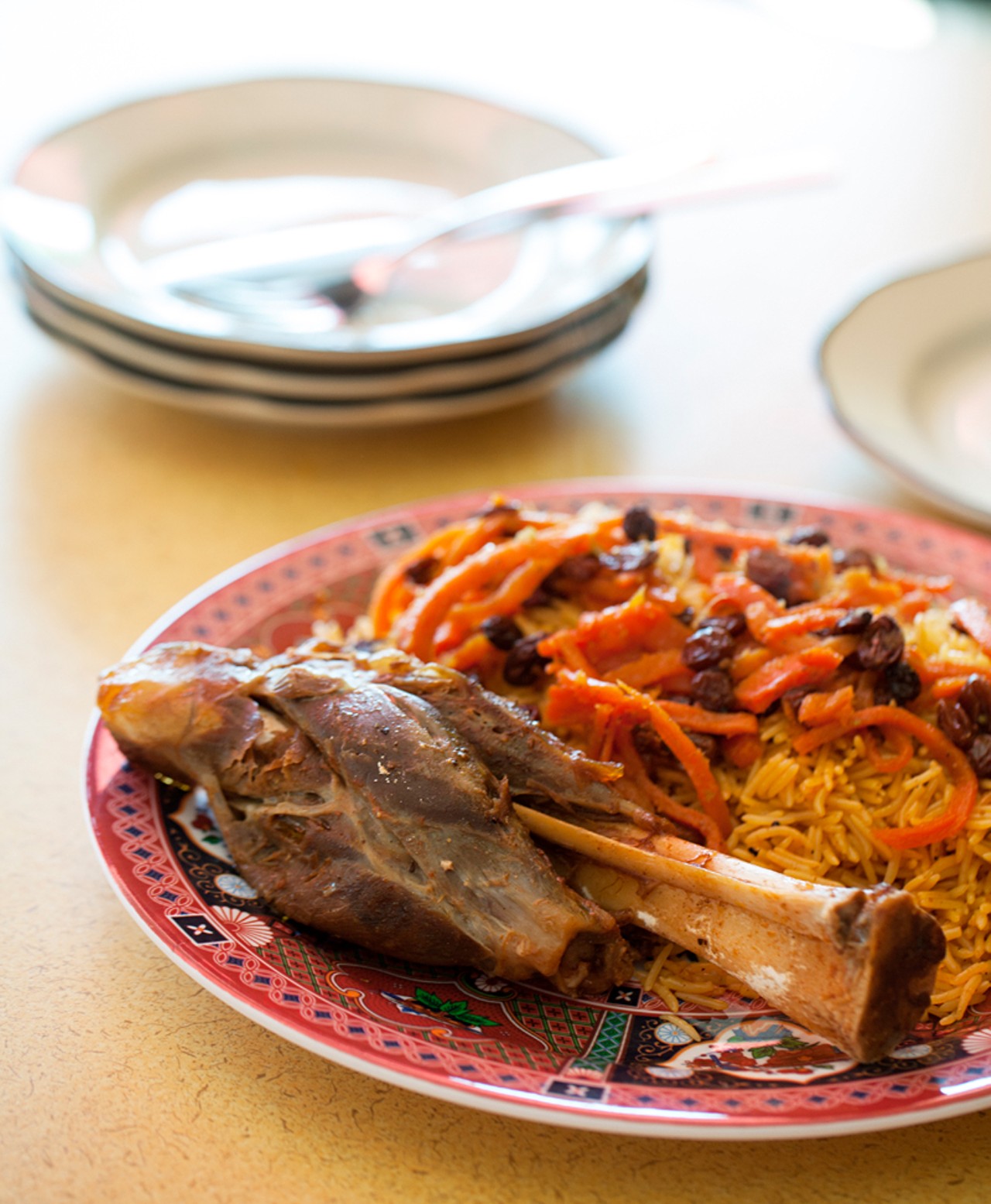 Lamb Qabelli is lamb shank with basmati rice with carrot and raisin, a single serving.