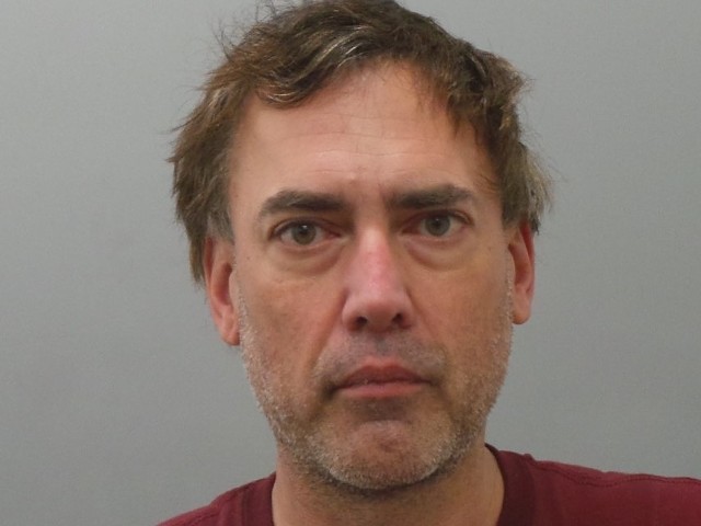 Robert Merkle, shown in a 2022 booking photo, was previously convicted of harassing women.