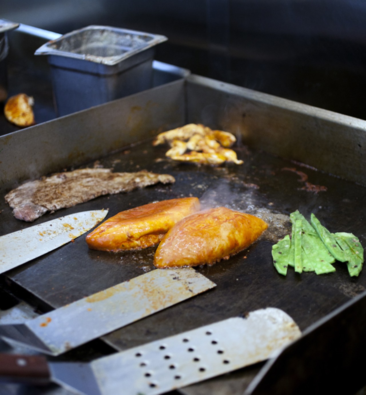 A variety of items being prepared on the grill