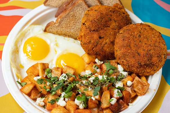 Salmon croquettes served with eggs, breakfast potatoes and toast.
