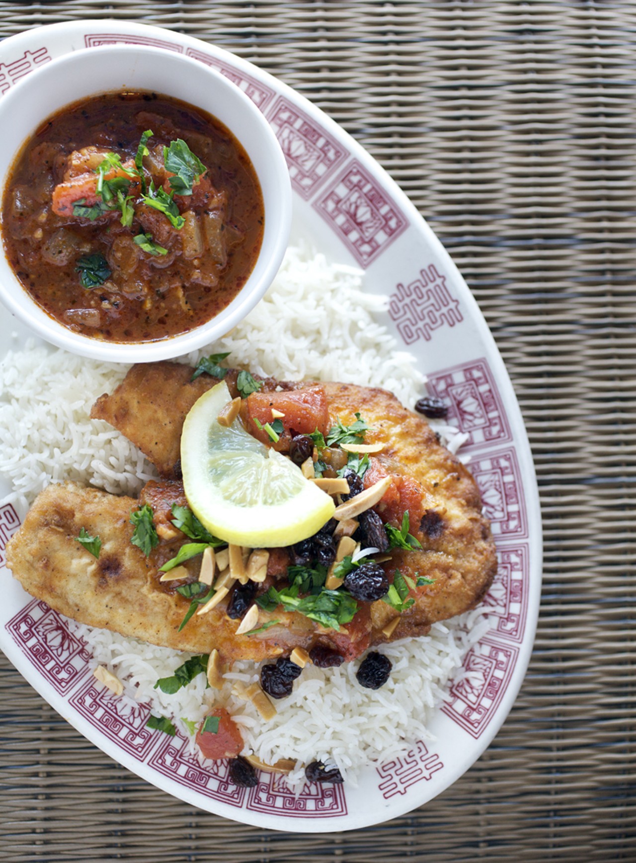 The Bedouin Fish is Tilapia served with a side of tomato sauce that is made from garlic, ginger, onion, chili peppers and mint. And is served with Basmati rice mixed with raisins, mint, parsley and crushed almonds.