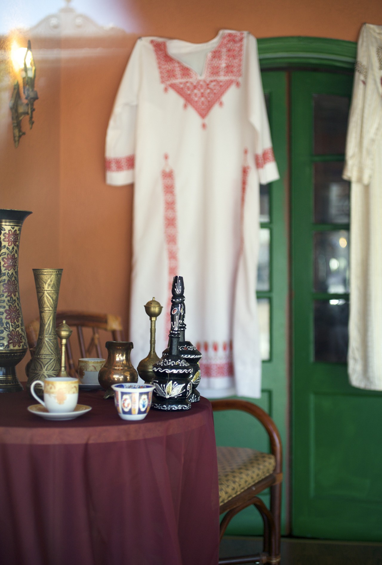 The inviting table in the window sits near two dresses that belonged to the Alwadi's mother. The dresses are Bedouin dresses, this one is handmade -- it would have taken about a month to make it.