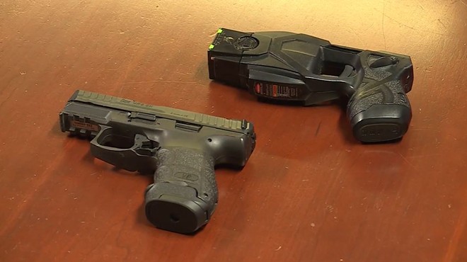 A comparison between the St. Ann police-issue Taser and sidearm  — both colored black.