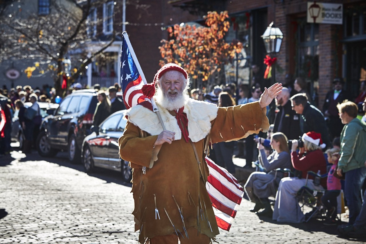 Frontier Santa parades down the street.  Back in the day, he delivered a tin cup, decorated sugar cookie or a piece of fruit to good children on the American frontier.