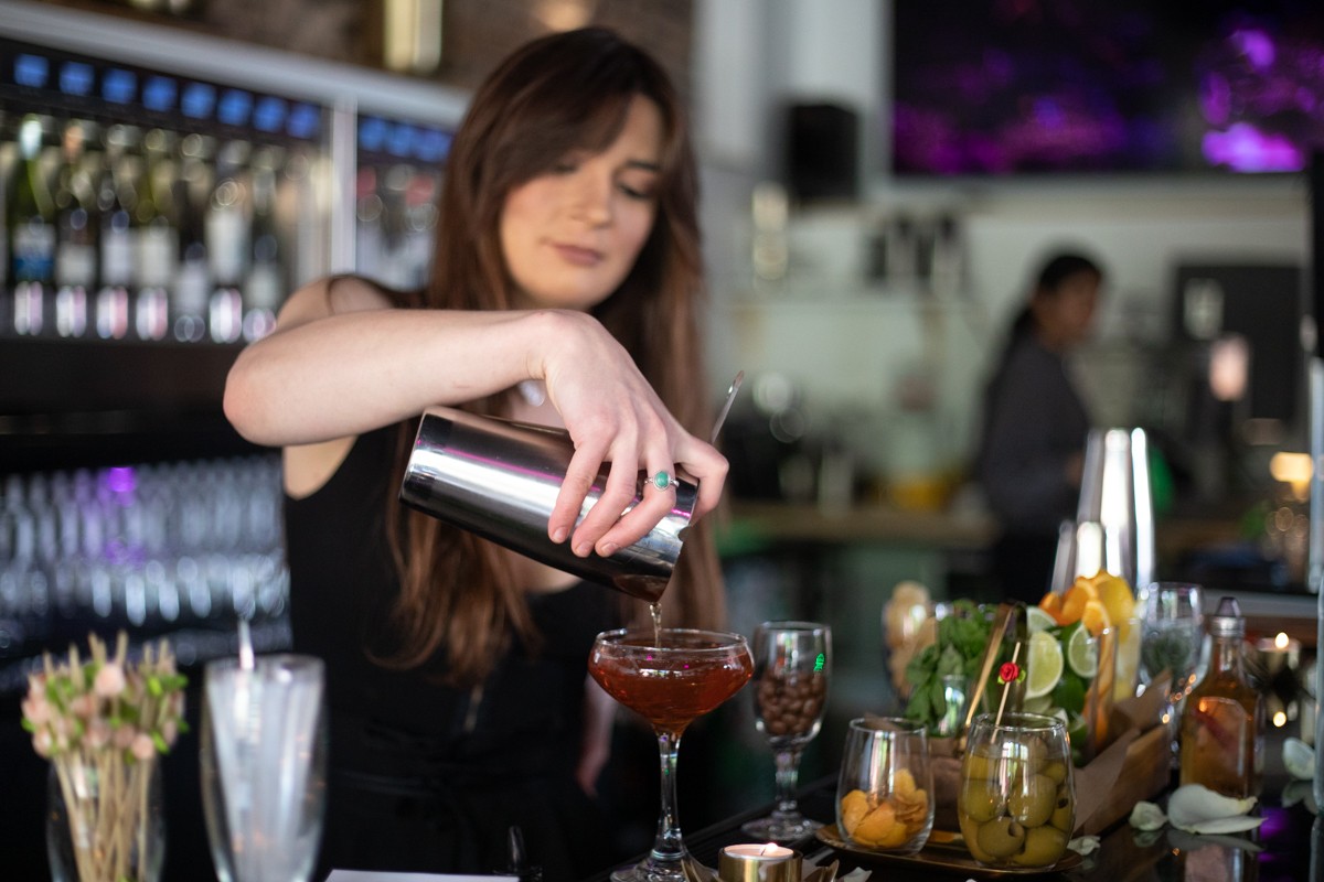 A bartender makes a drink at Rosé by Peno. The process for restaurants to get liquor licenses may see big changes — but only if aldermen can get on the same page.