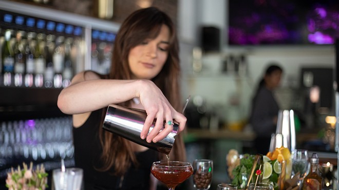 A bartender makes a drink at Rosé by Peno.
