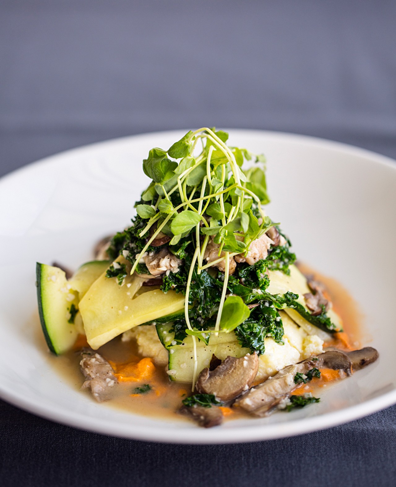 Autumn zucchini, kale and mushroom, served with creamy goat-cheese polenta and romesco sauce.