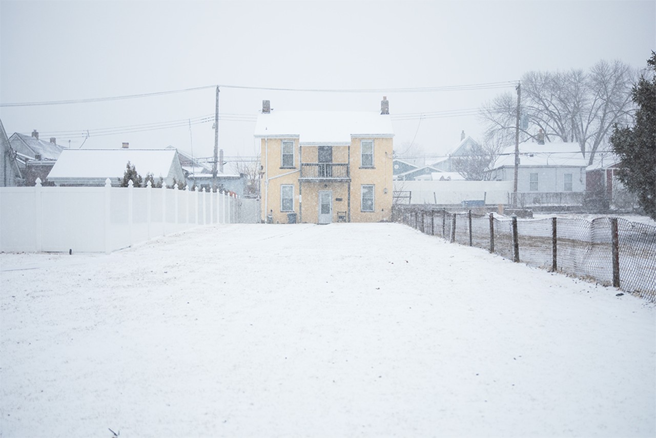 Snow falls over a house in the Hill neighborhood on Friday, Feb. 16, 2024.