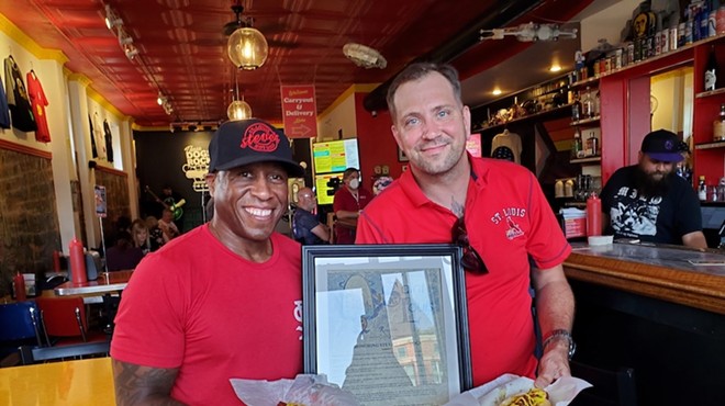 Founder and co-owner of Steve's Hot Dogs and Burgers, Steve Ewing, and Chef Joseph Zeable with the St. Louis-Style dog and the resolution from the City of St. Louis, making it the city's official hot dog.