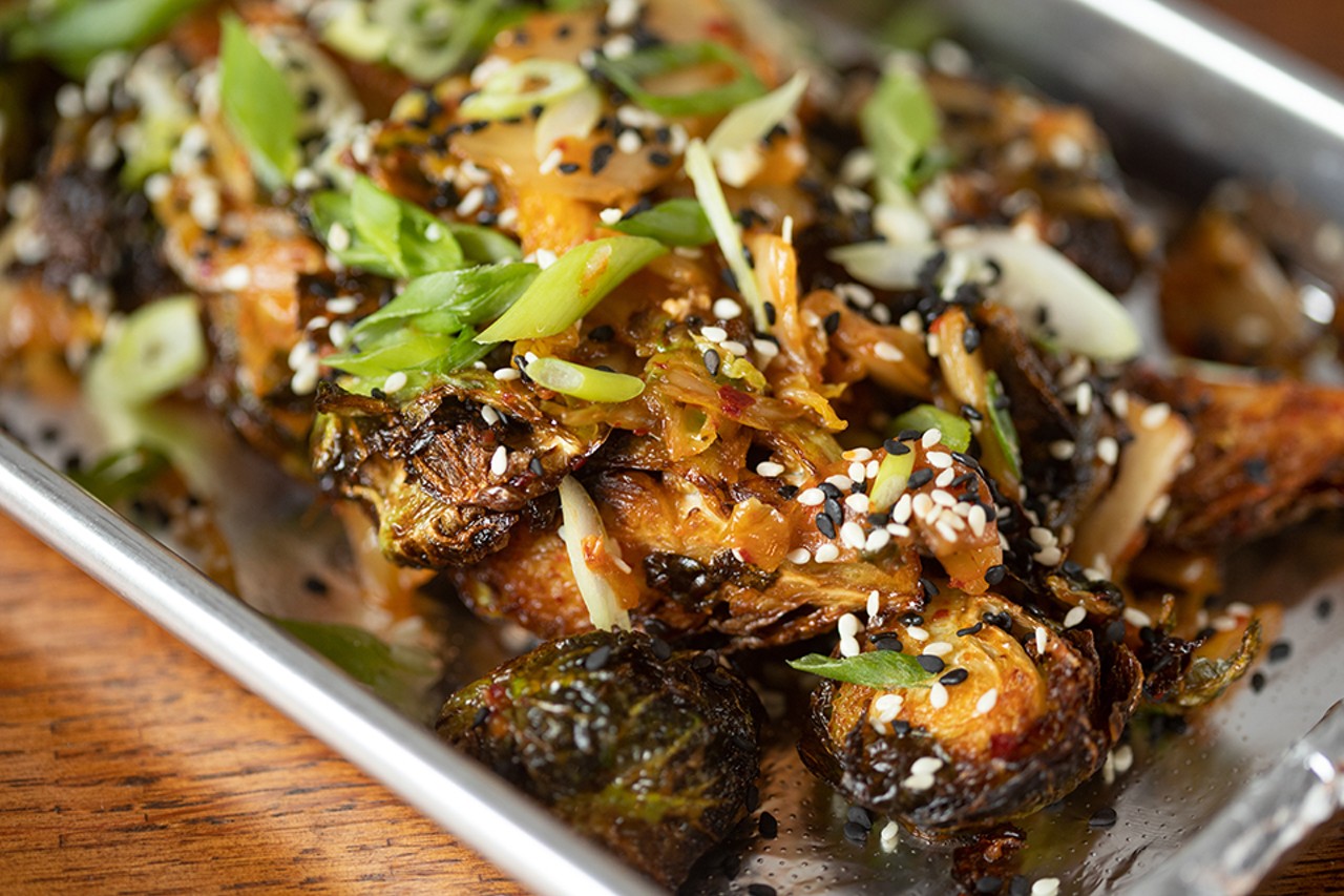 Kimchi brussels sprouts with fried sprouts, kimchi and toasted sesame.