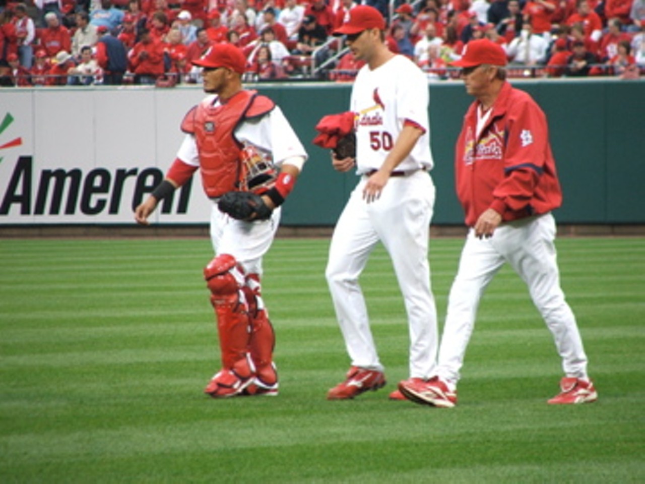 Left to right, Catcher Yadier Molina, starting pitcher Adam Wainwright, pitching coach Dave Duncan. They're taking the stroll from the bullpen to the field to start the game.