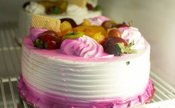 A cake topped with fruit.