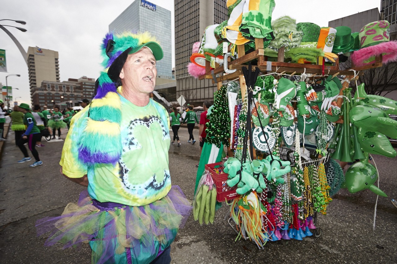 Steve Williford with Shallow Concessions  sells beads, hats and other novelties at the 37th Annual St. Patrick's Day Parade Run in downtown St. Louis on March 14, 2015.