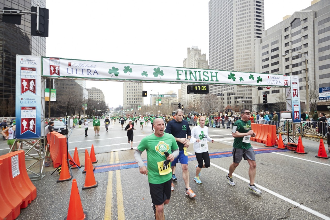 Runners trickle through the finish line at the 37th Annual St. Patrick's Day Parade Run in downtown St. Louis on March 14, 2015.