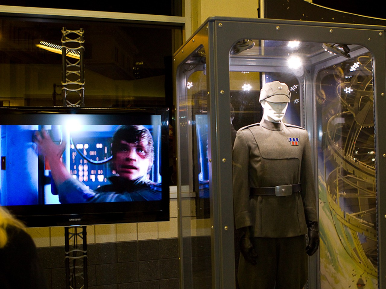 Scenes from the Star Wars movies were playing on huge TV's alongside costumes and props used in the movies.