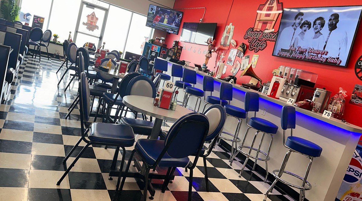 Sugar Shack’s interior features a checkerboard floor, lollipop-red walls and peacock-blue stools at the counter and good old Southern food.