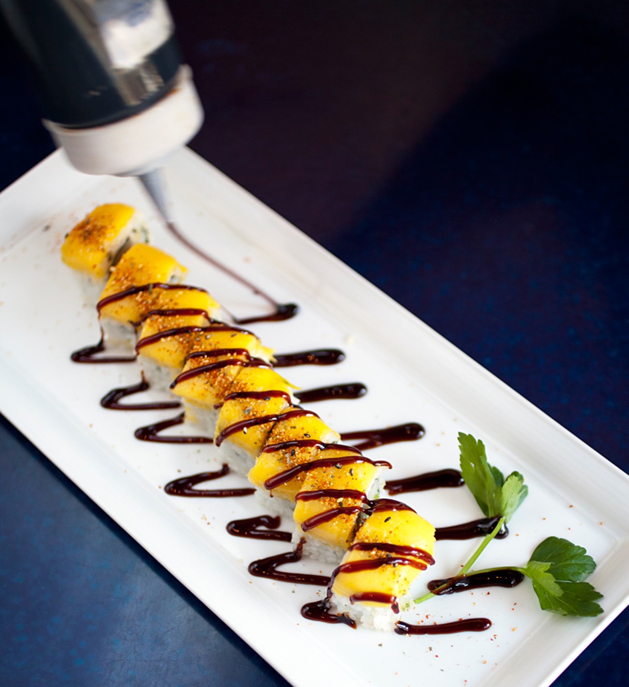 The Golden Child, one of Hiro's specialty rolls with white tuna, tempura crunch, avocado topped with mango and eel sauce.