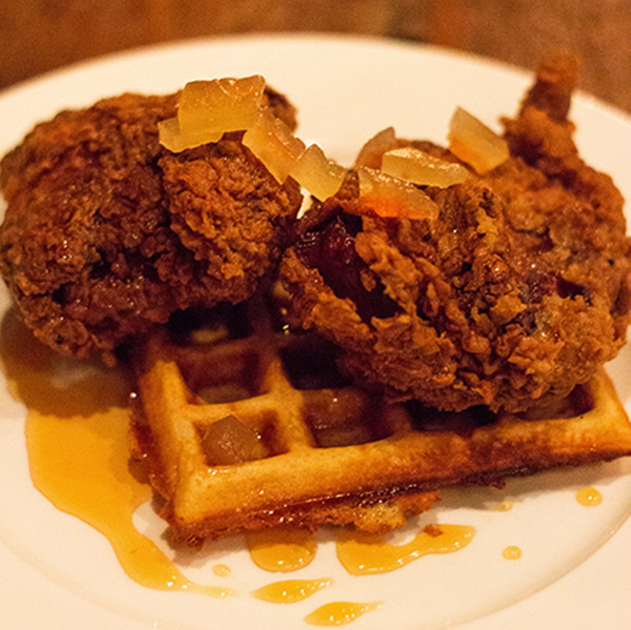 Haute Chicken and Waffles
In a 2008 episode of his television show Fatherhood, Snoop Dogg took David Beckham to his favorite dining spot, Roscoe's Chicken and Waffles, for a taste of L.A.'s famous soul food. The tables were formica, the menus were covered in plastic sneeze guards, and a wine pairing meant ordering a Bartles & James from the beverage list. Roscoe's wasn't being ironic. It was just serving honest soul food, smothered in syrup and grease, to those looking for Southern-inspired comfort. Fast-forward five years, and this once humble fried fare has found its way onto the chicest menus in town. Sandwiched somewhere between foie gras and truffles, chicken and waffles has achieved haute status. No longer is simple maple syrup sufficient for such an elite dish. Now highbrow, they come topped with everything from poached quail egg to sriracha aioli. There are online resources dedicated to chicken-and-waffles wine pairings, and even the venerable Thomas Keller has gotten in on it. Granted, some of the world's most notable dishes had humble beginnings -- think cassoulet or pizza -- but this seems like more of a short-lived trend than a permanent fixture on upscale menus. Any excuse to don eveningwear and dig our manicured fingers into a platter of diner food is good by us, but being charged a week's salary for something we can get at IHOP feels a bit like a rip-off. -- Cheryl Baehr