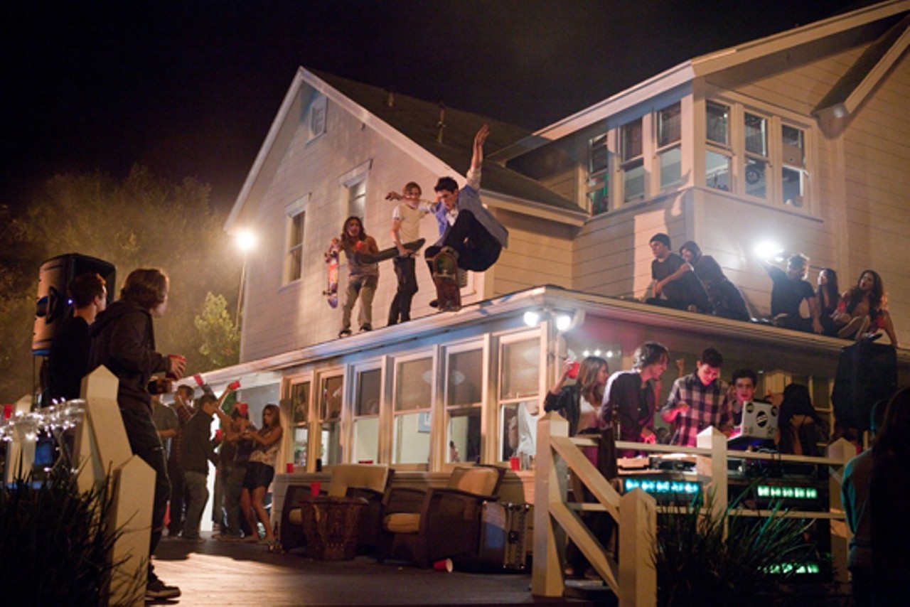7. Project X (2012)If you had to sum up what the Project X is like in one scene, describe the image above: A teenager doing what every teenager who's set foot on a skateboard has dreamed about, a sick ollie off the roof of someone's house. That photo is this film in a sentence. You half-expect one of them to buy a van with a fantasy scene painted on the side and one of those port-holes on the back, and drive literally anywhere they want, on acid.
