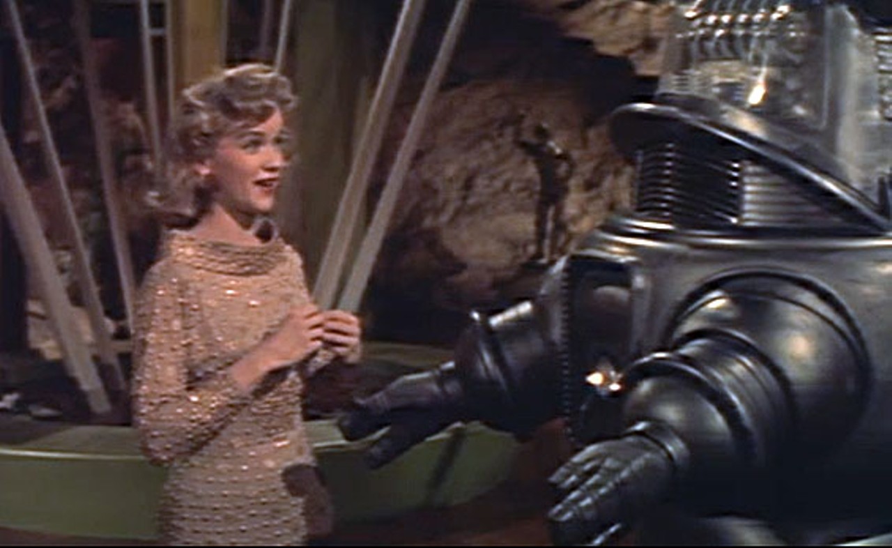 9. Forbidden Planet (1956)
A dutiful robot named Robby speaks 188 languages. An underground lair provides astonishing evidence of a populace a million years more advanced than earthlings. There are many wonders on Altair-4, but none is greater or more deadly than the human mind. Forbidden Planet is the granddaddy of tomorrow, a pioneering work whose ideas and style would be reverse-engineered into many cinematic space voyages to come. Leslie Nielsen portrays the commander who brings his spacecruiser crew to the green-skied Altair-4 world that's home to Dr. Morbius (Walter Pidgeon), his daughter (Anne Francis), the remarkable Robby...and to a mysterious terror.