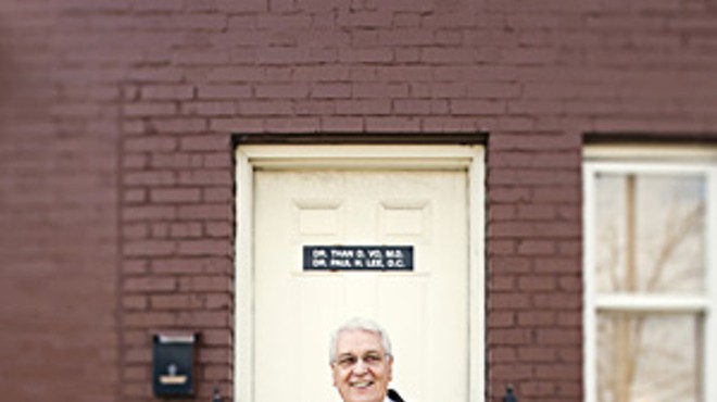 William Chignoli on the front steps of Acci&oacute;n Social Comunitaria's clinic on South Grand Boulevard.