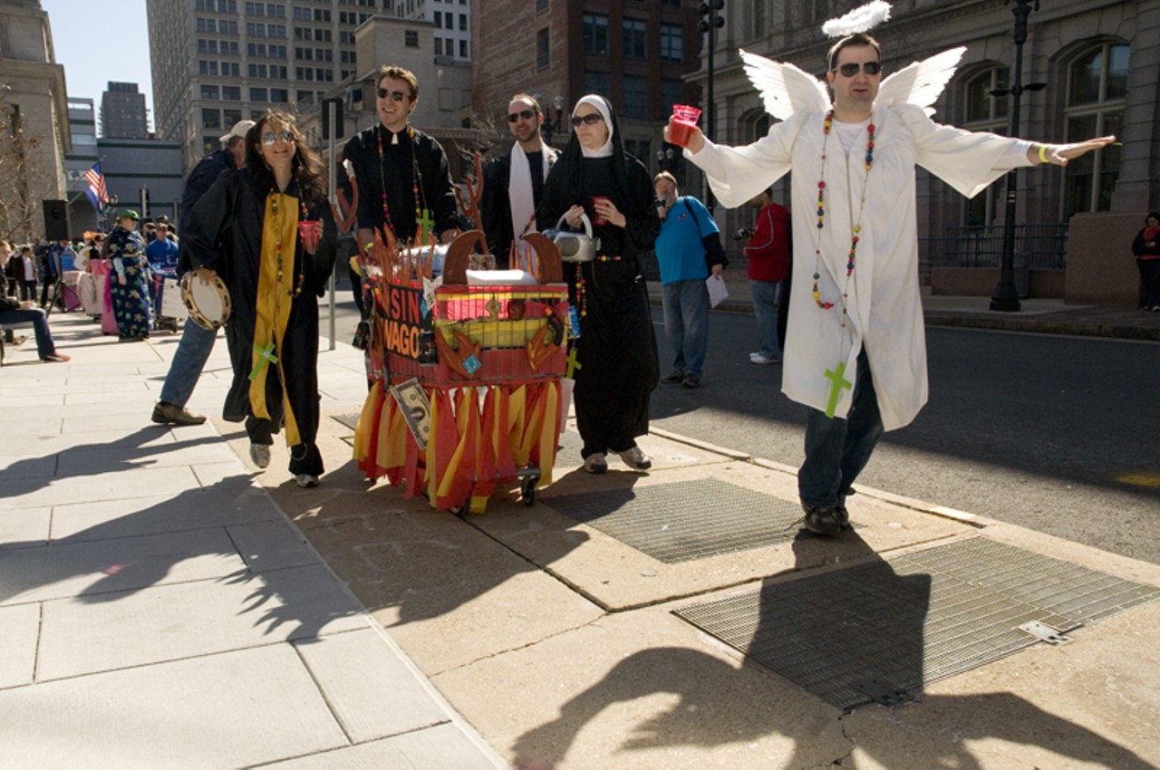 The Holy Rollers strut in front of the crowds of people during the pageant segment of the Idiotarod festivities in downtown.&nbsp;