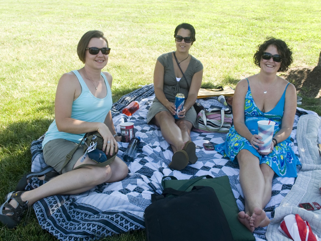 Fans grab a scarce spot of shade to beat the heat at Lilith Fair in St. Louis.