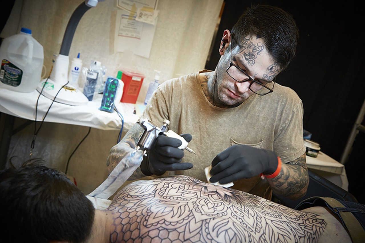 Nathan Wilson from Detroit works on a large back tat.
