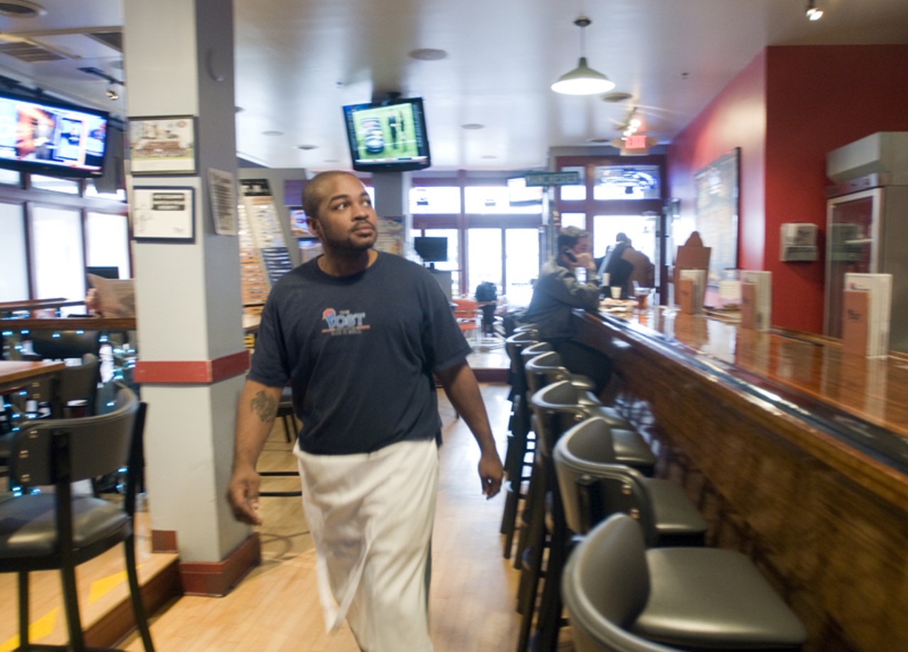 Restaurant manager Tashon Hagins walks the floor to make sure everything is in order.
