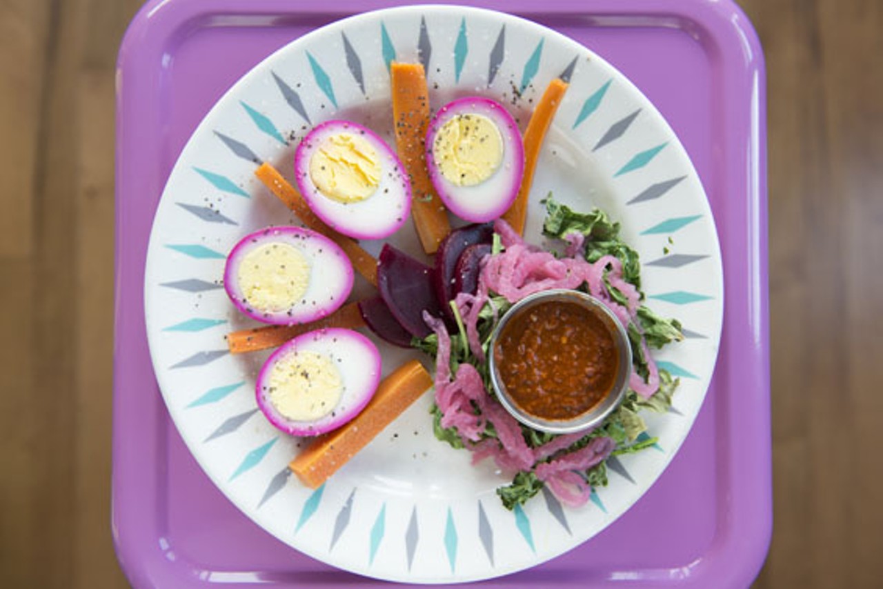 The "Purple Martin Nest" brings hard-boiled eggs that are marinated in beets and served alongside pickled veggies, greens and harissa.