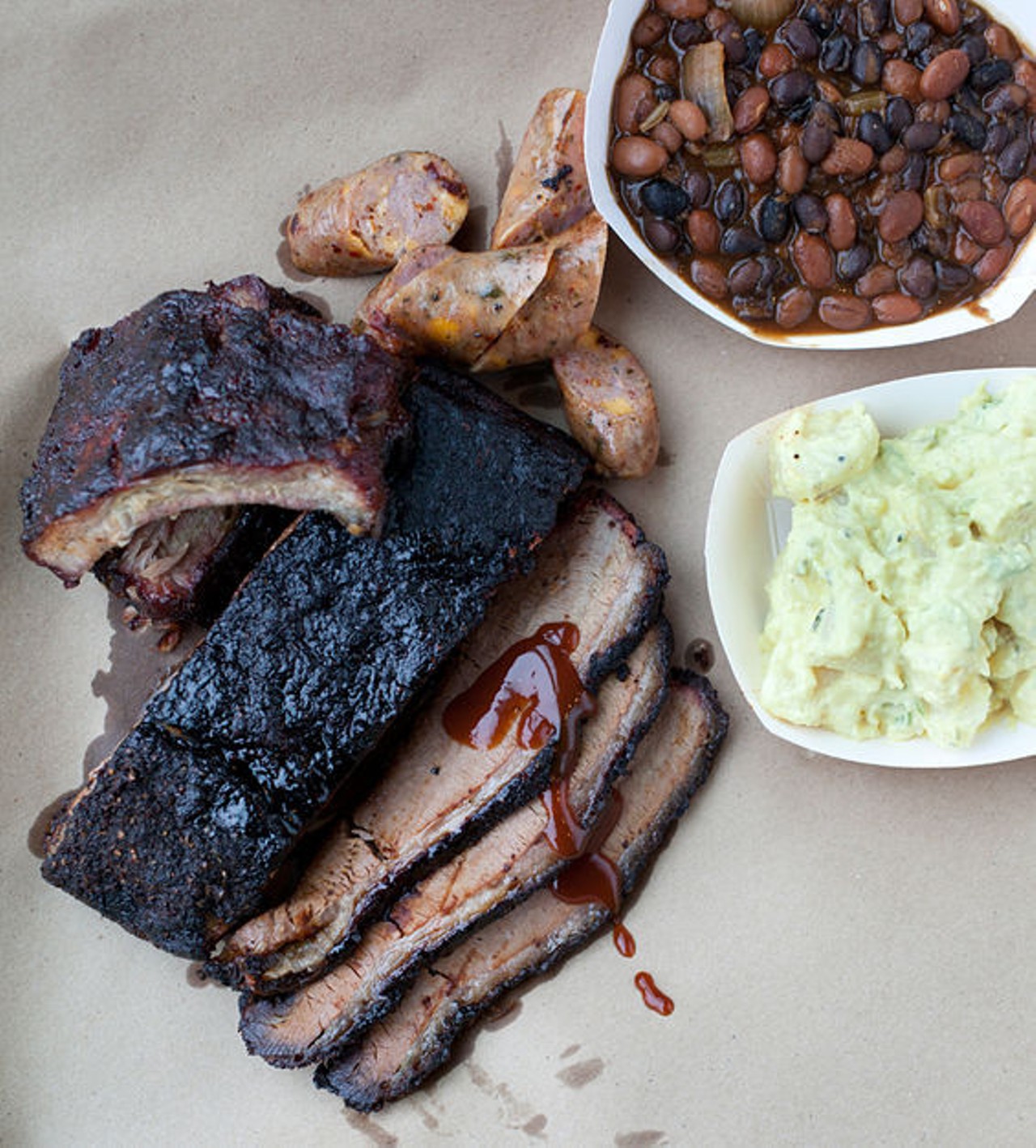 A display of the brisket, baby back ribs, housemade jalapeno sausage, baked beans and potato salad. See more photos: Inside the Sugarfire Smoke House.