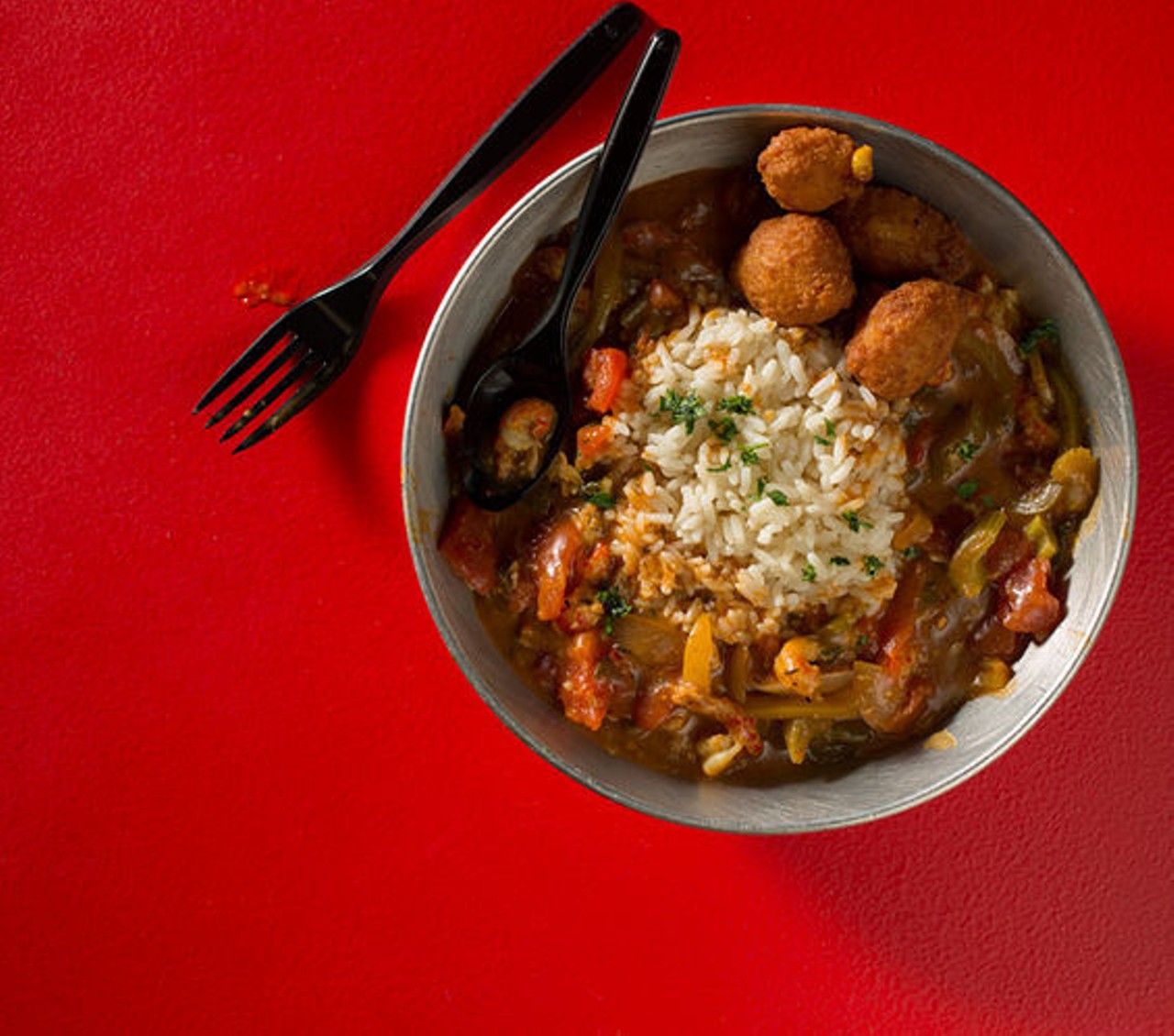 Etouffee is a creole dish with peppers, onions, celery. Here, it's shown with crawfish, and served over a bed of rice. See more photos: Inside The Kitchen Sink near Forest Park.