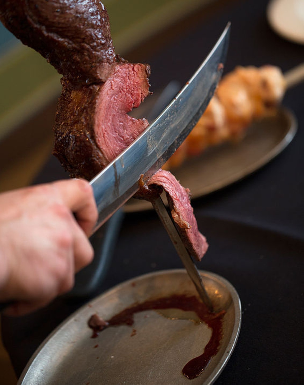 Cutting the Skewer of Picanha, the house sirloin. See more photos: Inside Brazikat Brazilian Steak & Seafood House.