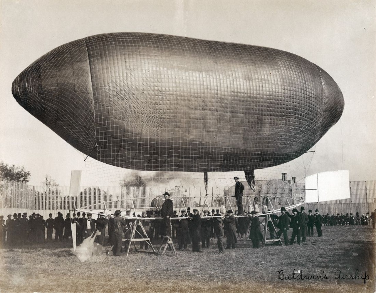 "BALDWIN'S AIRSHIP." (SHIP READY FOR TAKEOFF WITH ROY KNABENSHUE STANDING ON THE FRAME. DEPARTMENT OF TRANSPORTATION EXHIBIT AT THE 1904 WORLD'S FAIR).
Find out more about this photo at MoHistory.org.