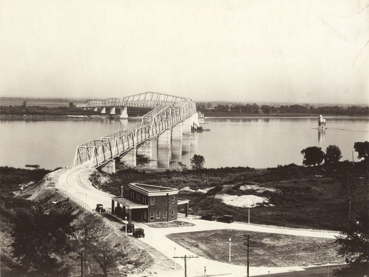 CHAIN OF ROCKS BRIDGE, 1929. ROUTE 66 (1936 - 1955), ROUTE 66 BYPASS (1956 - 1965)
"The bridge's famous 22-degree dogleg bend resulted from the Corps of Engineers' demands that the bridge face riverboat traffic head on. The Chain of Rocks Bridge closed in 1970, just after the toll-free Interstate 270 bridge opened up stream. In 1981 it served as a backdrop in the dystopian sci-fi film 'Escape from New York.' Finally in 1999, Trailnet reopened the bridge as a bicycle and pedestrian crossing." &#151; Andrew Wanko, 'Great River City' 
Photograph by W.C. Persons, 1929. Missouri Historical Society Collections.
