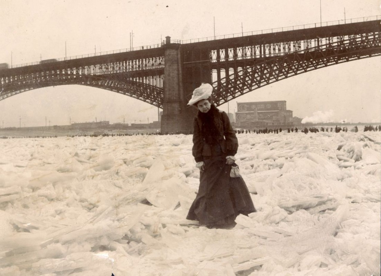 THE MISSISSIPPI RIVER FROZEN SOLID, FEBRUARY 1905
"St. Louisans couldn't resist feeling the frozen river beneath their feet &#151; especially after photography became widespread and they could snap a photo of themselves doing it. The frozen Mississippi was a novelty even worthy of a postcard for those who couldn't see it for themselves." &#151; Andrew Wanko, 'Great River City'
Woman crossing frozen river during the Ice Gorge of 1905. Photograph, 1905. Missouri Historical Society Collections.
